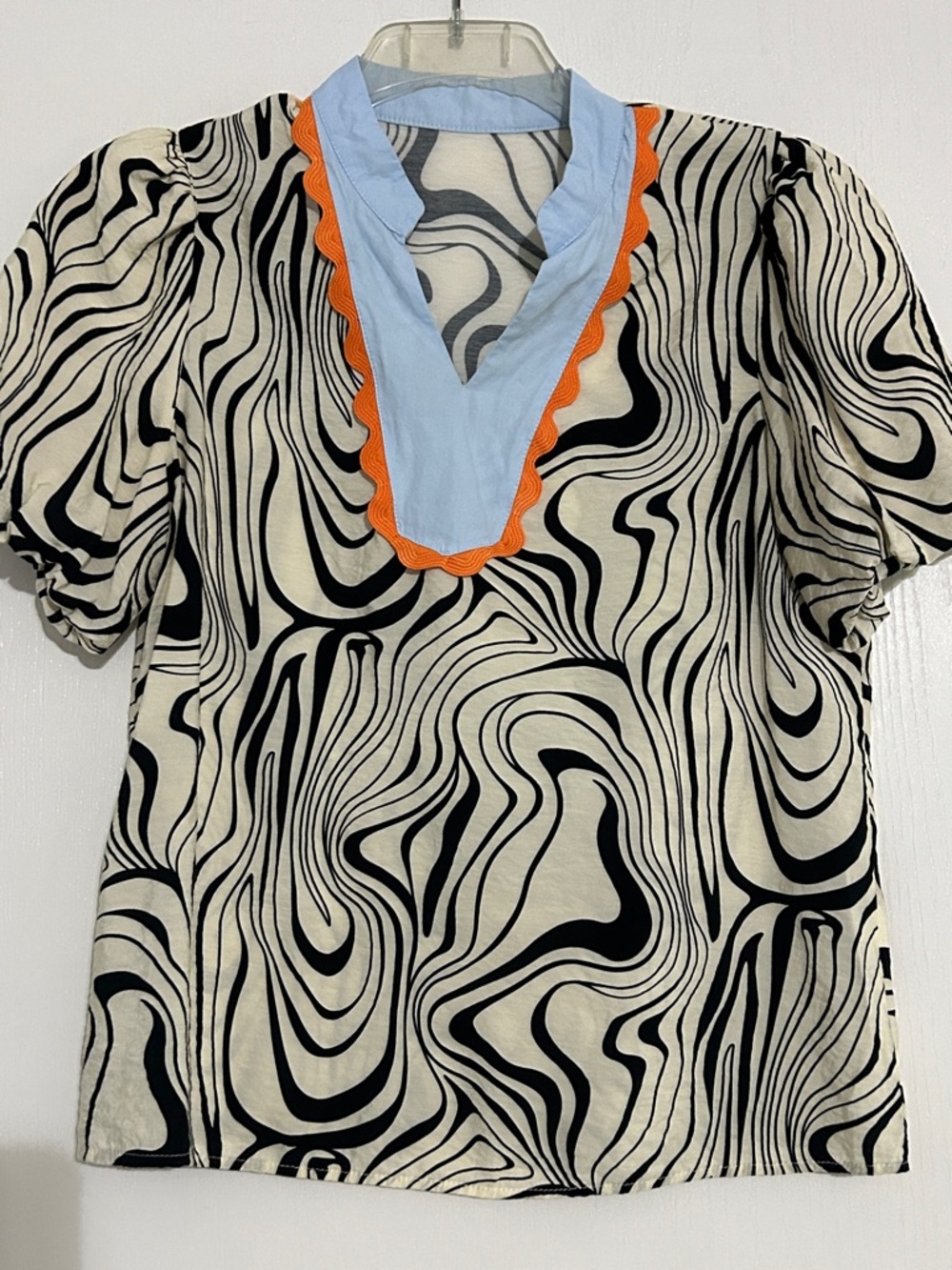 Women’s Black & Cream Swirl Print Top with Light Blue V-Neck and Orange Trim